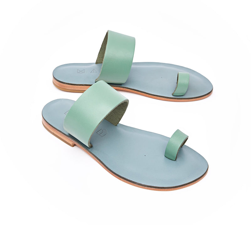 Angled view of the handmade Root women's slip-on leather sandals in light grey insole with light green straps / GREEN