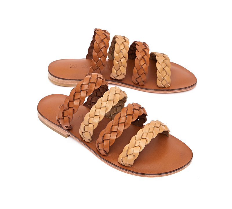Angled view of the handmade Sea women's braided slip-on leather sandals in light brown insole with natural tan and light brown straps / TAN BROWN