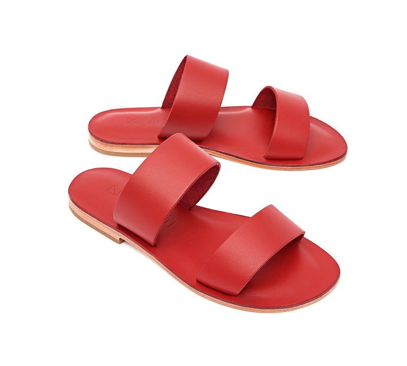 Angled view of the handmade Sun women's slip-on leather sandals in red / RED