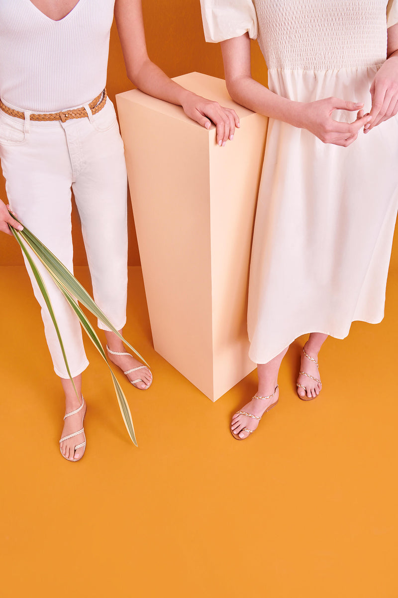 Model wearing the handmade Salt women's braided slingback leather sandals in natural tan insole with gold silver straps / GOLD SILVER