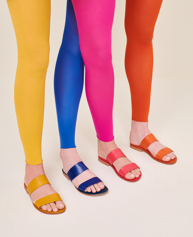 Model wearing the handmade Sun women's slip-on leather sandals in orange / ORANGE