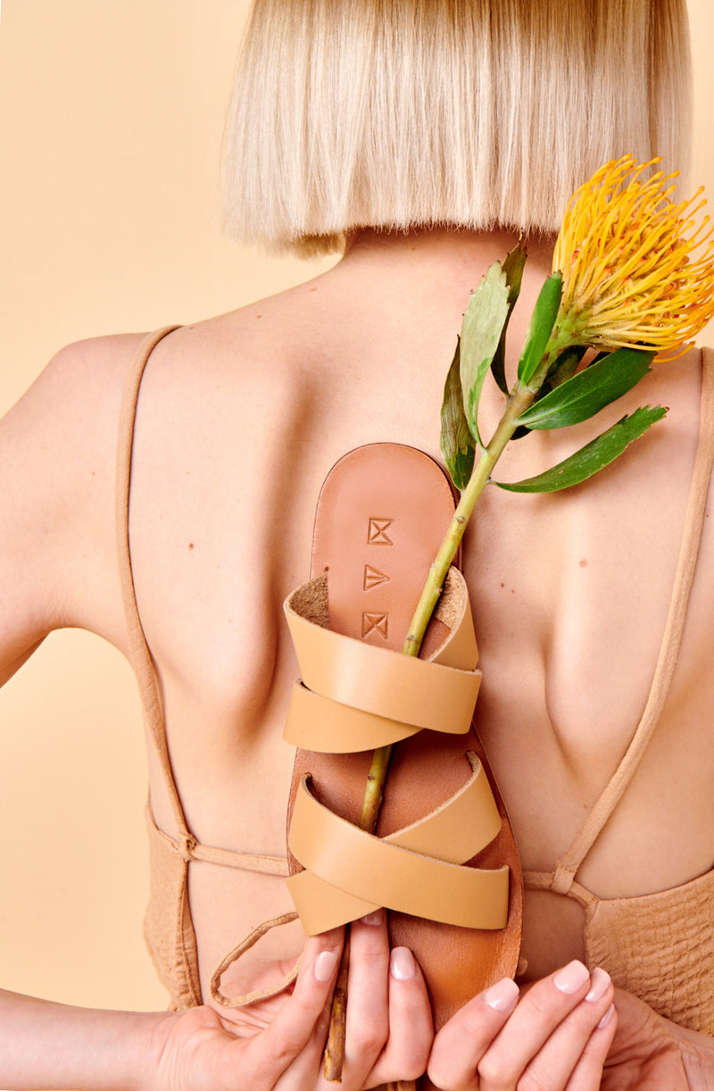 Model wearing the handmade Wave women's slip-on leather sandals in light brown insole with natural tan straps / TAN