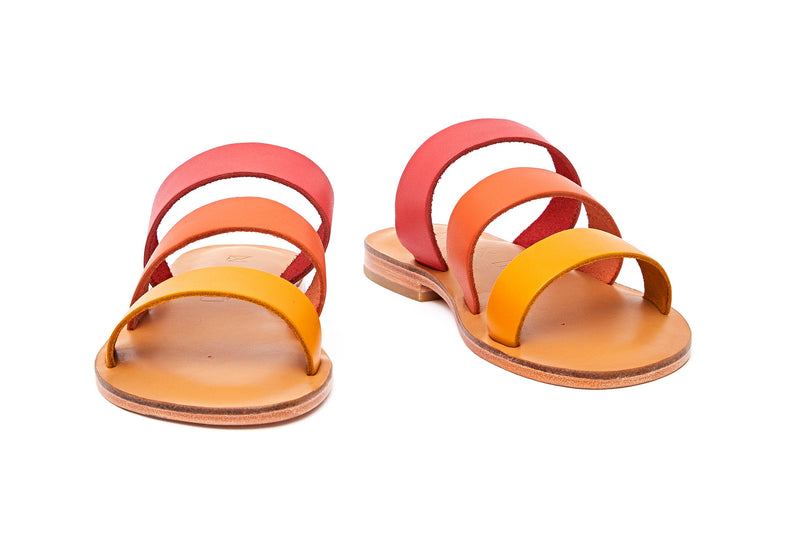 Front view of the handmade Sky women's slip-on leather sandals in natural tan insole with pomegranate, orange and yellow straps / SUNSET