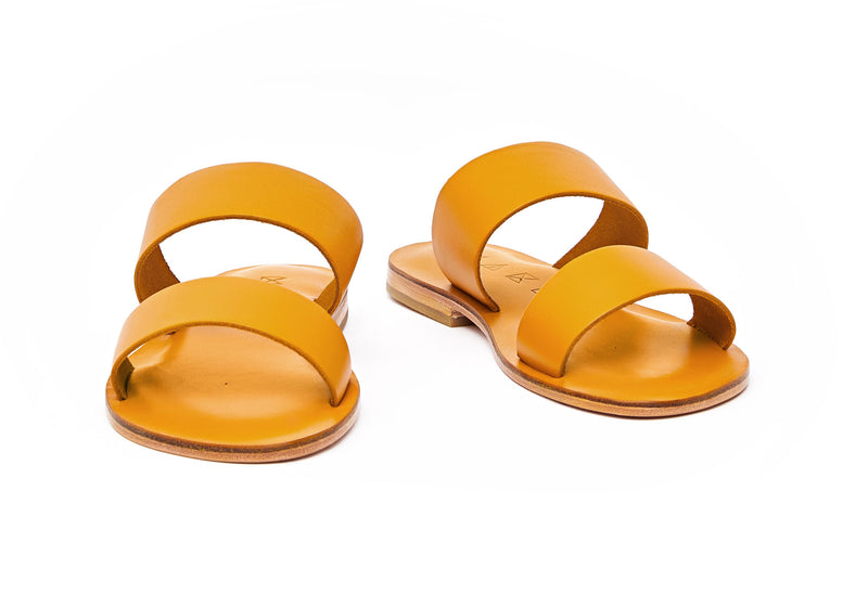 Front view of the handmade Sun women's slip-on leather sandals in yellow / YELLOW
