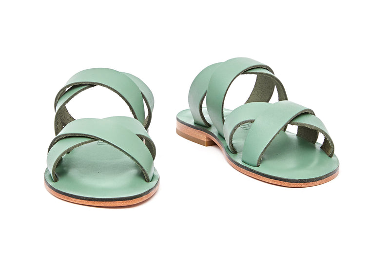 Front view of the handmade Wave women's slip-on leather sandals in light green / GREEN