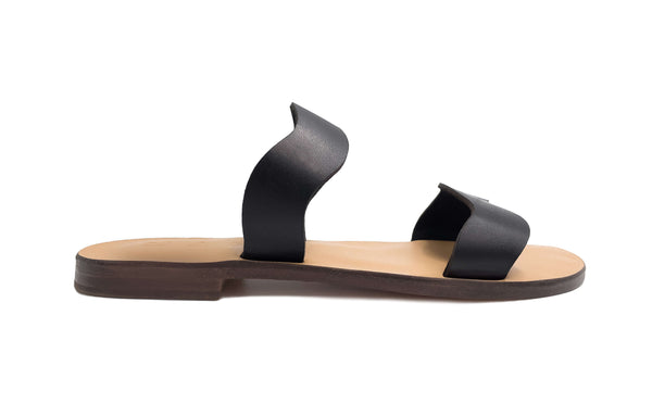 Side view of the handmade Mare women's slip-on leather sandals with tan insoles and black straps / BLACK