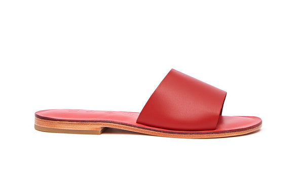 Side view of the handmade Rock women's slip-on leather sandals in pomegranate insole with red straps / RED