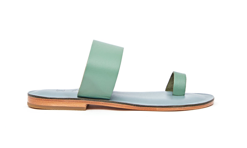 Side view of the handmade Root women's slip-on leather sandals in light grey insole with light green straps / GREEN