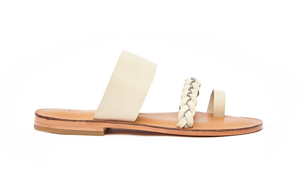 Side view of the handmade Sand women's braided slip-on leather sandals in natural tan insole with cream straps / CREAM