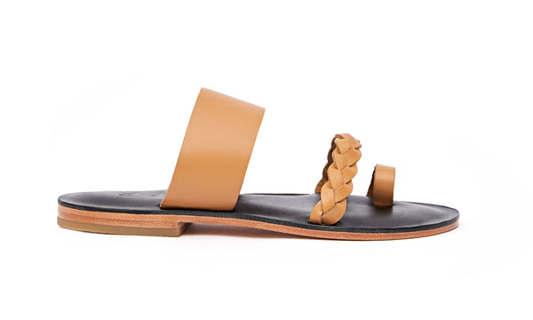 Side view of the handmade Sand women's braided slip-on leather sandals in black insole with natural tan straps / TAN BLACK