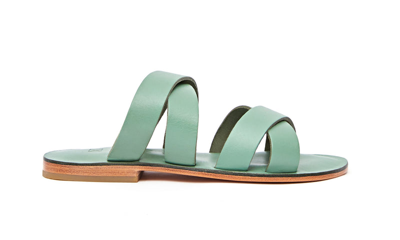 Side view of the handmade Wave women's slip-on leather sandals in light green / GREEN