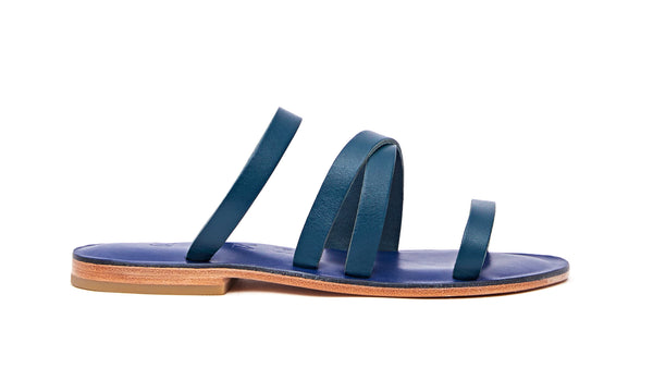 Side view of the handmade Wind women's slip-on leather sandals in night blue / MEDITERRANEAN