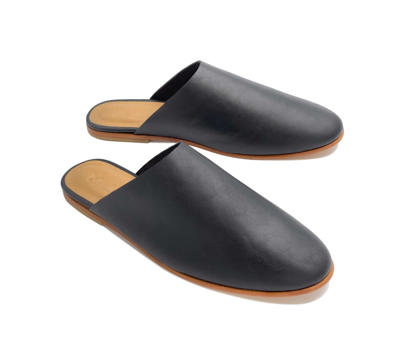 Angled view of the handmade Mule women's slip-on leather sandals in black / BLACK