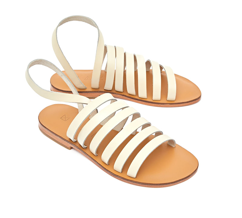 Angled view of the handmade Ray women's slingback leather sandals in natural tan insole with cream straps / CREAM