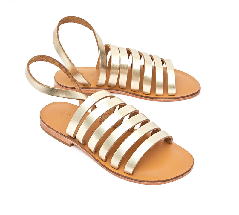 Angled view of the handmade Ray women's slingback leather sandals in natural tan insole with gold straps / GOLD