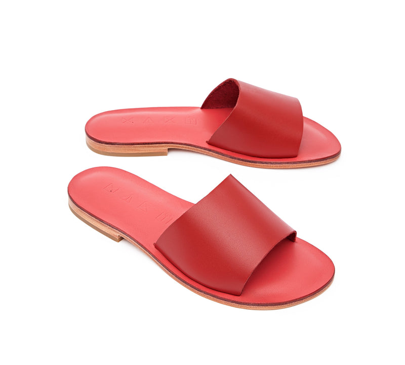 Angled view of the handmade Rock women's slip-on leather sandals in pomegranate insole with red straps / RED