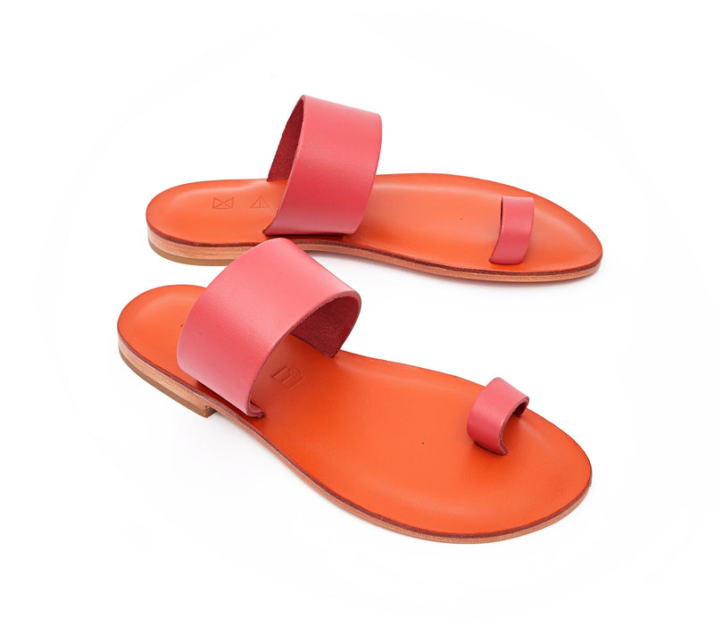 Angled view of the handmade Root women's slip-on leather sandals in orange insole with pomegranate straps /  POMEGRANATE