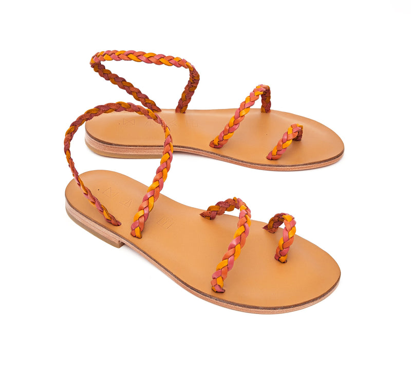 Angled view of the handmade Salt women's braided slingback leather sandals in natural tan insole with pomegranate, orange and yellow straps / SUNSET