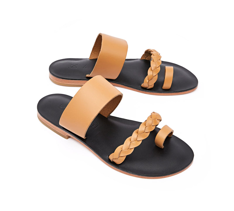 Angled view of the handmade Salt women's braided slip-on leather sandals in black insole with natural tan straps / TAN BLACK