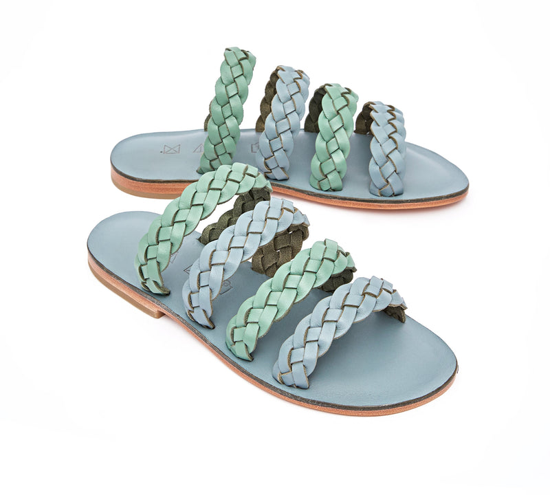 Angled view of the handmade Sea women's braided slip-on leather sandals in light grey insole with light green and grey straps / GREY GREEN