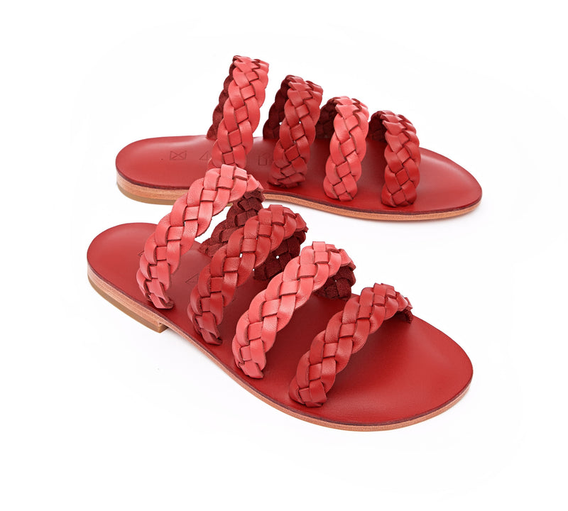Angled view of the handmade Sea women's braided slip-on leather sandals in red insole with pomegranate and red straps / RED POMEGRANATE