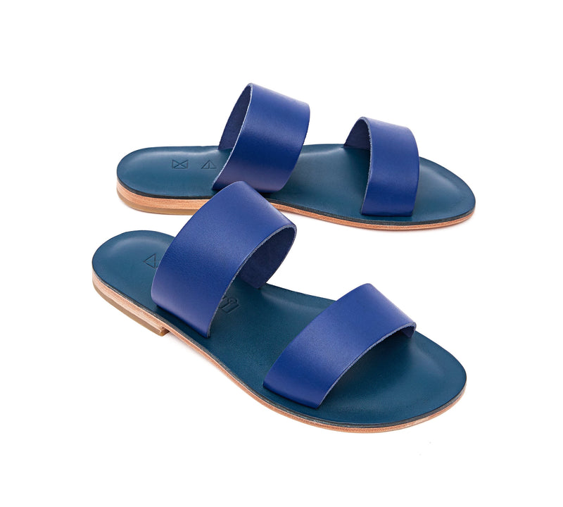 Angled view of the handmade Sun women's slip-on leather sandals in night blue / BLUE