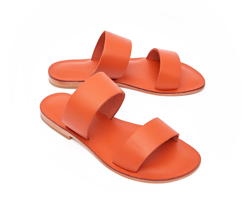 Angled view of the handmade Sun women's slip-on leather sandals in orange / ORANGE