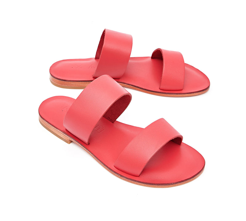 Angled view of the handmade Sun women's slip-on leather sandals in pomegranate / POMEGRANATE