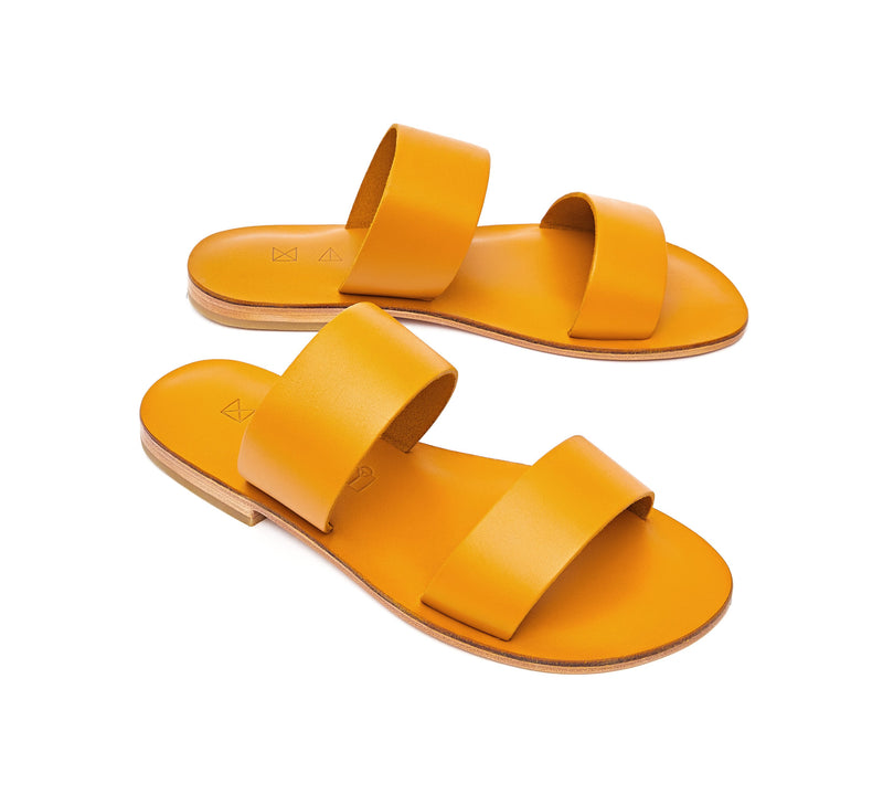Angled view of the handmade Sun women's slip-on leather sandals in yellow / YELLOW