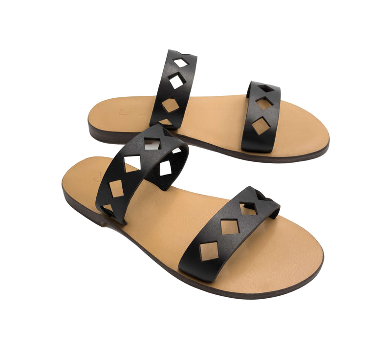Angled view of the handmade Terra women's slip-on leather sandals with tan insoles and black straps / BLACK