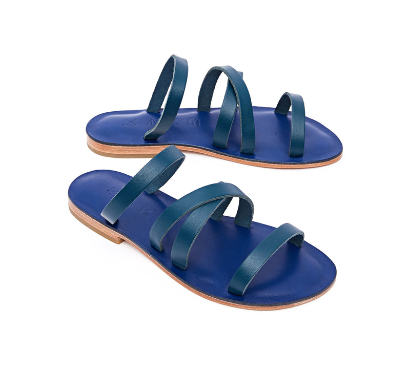 Angled view of the handmade Wind women's slip-on leather sandals in night blue / MEDITERRANEAN