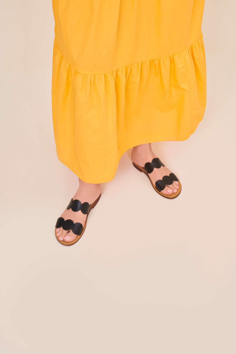 Model wearing the handmade Sol women's slip-on leather sandals in natural tan insole with black straps / BLACK